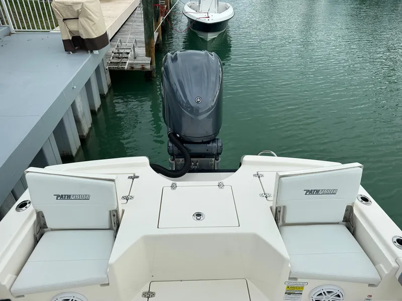 Slide: The Image of 2021 Pathfinder 2500 Hybrid boat with outboard motor docked in marina. - 9