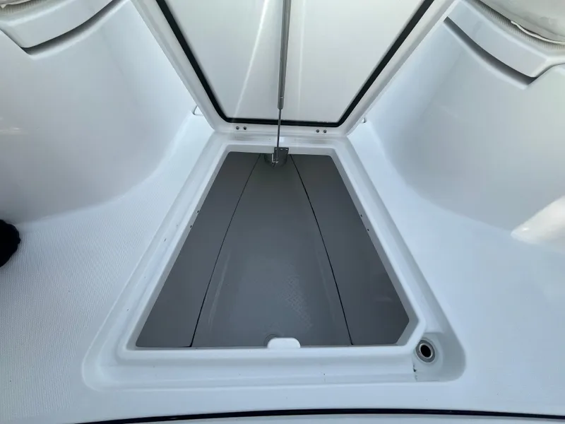 Slide: The Image of 2025 Everglades 335 Center Console storage compartment, open and empty, showcasing interior space. - 12