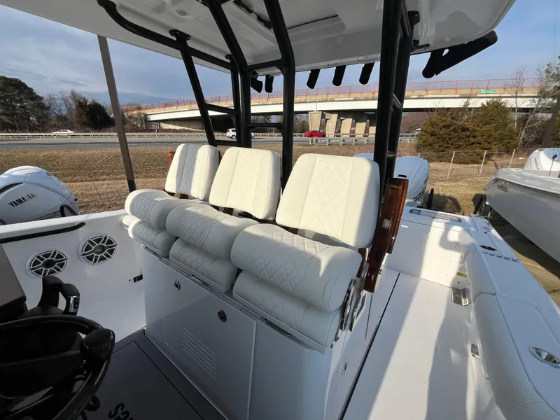 Slide: The Image of 2025 Everglades 335 Center Console boat with white seating and modern design. - 2