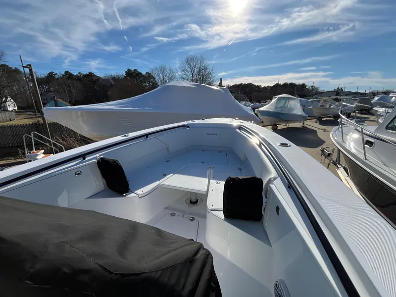 Slide: The Image of 2025 Everglades 335 Center Console boat in a marina under a clear blue sky. - 6