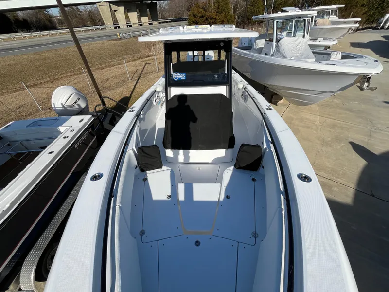 Slide: The Image of 2025 Everglades 335 Center Console boat, docked, showcasing spacious deck and modern design. - 7