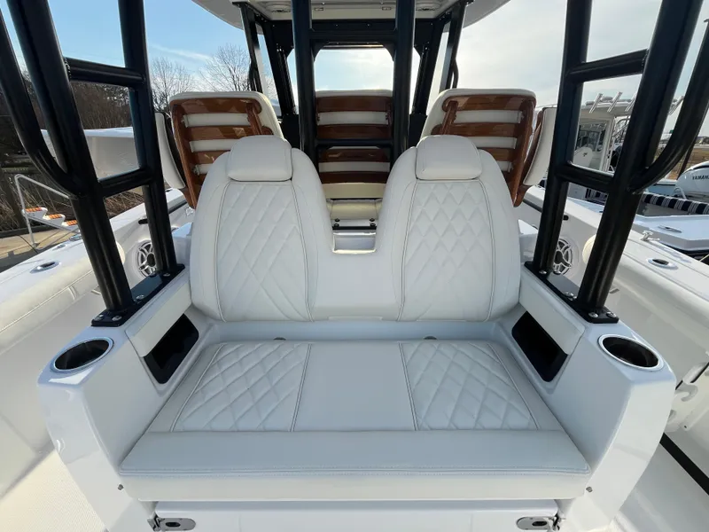 Slide: The Image of 2025 Everglades 335 Center Console boat with luxurious white seating and cup holders. - 9