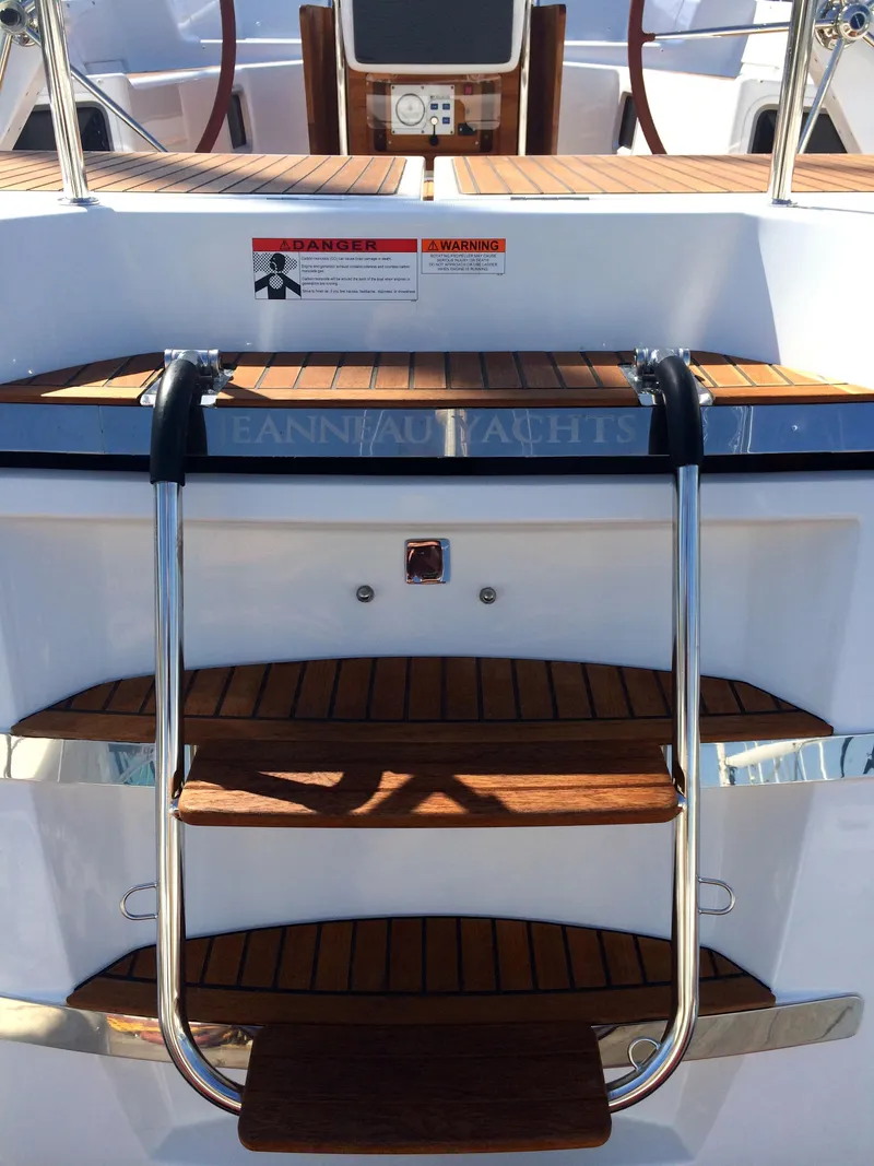 Slide: The Image of 2011 Jeanneau 57 yacht with wooden steps and stainless steel ladder. - 49