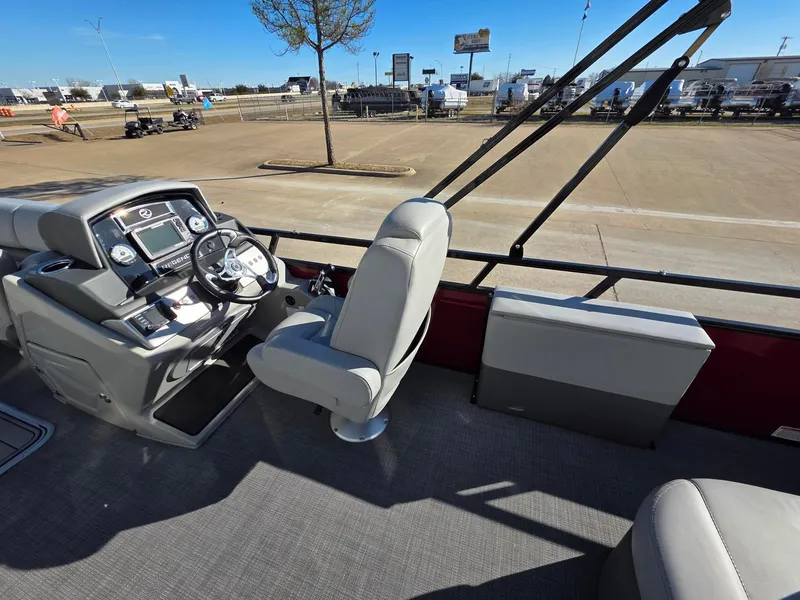 Slide: The Image of 2023 Regency 250 DL3 boat interior with steering console and seating. - 3