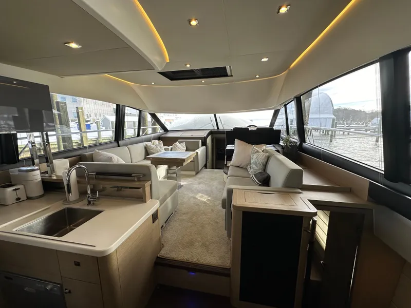 The Image of Luxurious interior of a 2017 Prestige 500 yacht with modern furnishings and panoramic windows. - 0