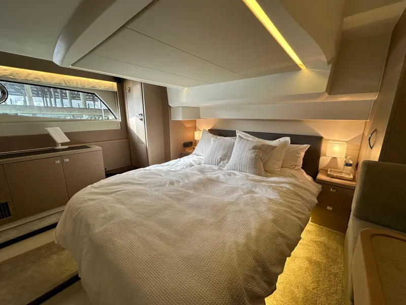 Slide: The Image of Luxurious bedroom interior of a 2017 Prestige 500 yacht with elegant lighting and cozy bedding. - 17
