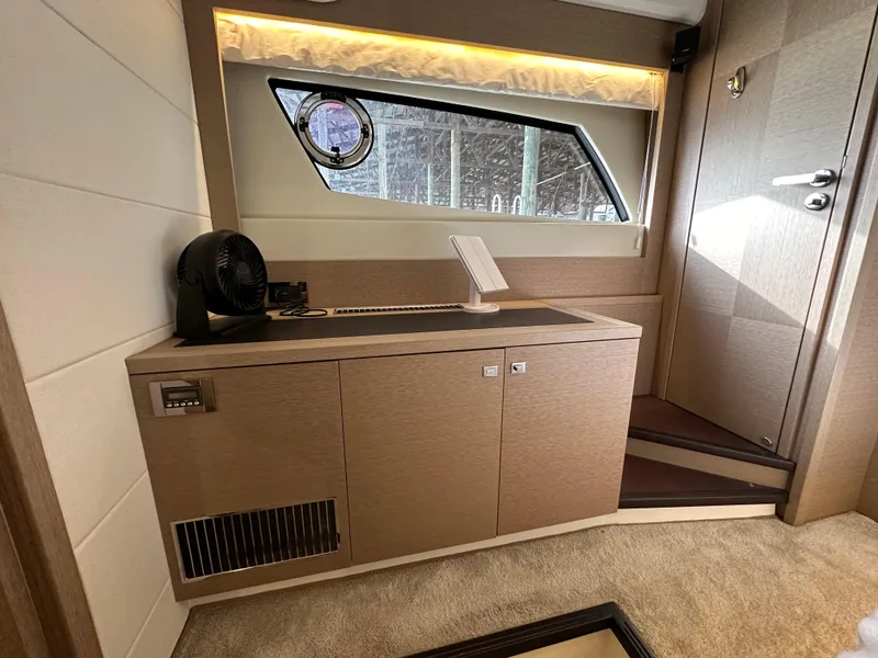 Slide: The Image of Interior of 2017 Prestige 500 yacht with modern cabinetry and window view. - 18