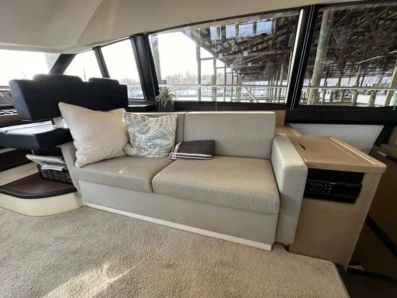 Slide: The Image of Luxurious interior of a 2017 Prestige 500 yacht with a comfortable sofa and scenic windows. - 8