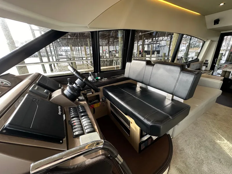 Slide: The Image of Interior of a 2017 Prestige 500 yacht, featuring a modern helm and seating area. - 9