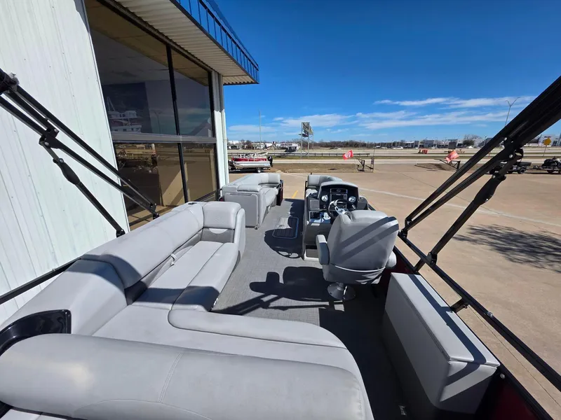 Slide: The Image of 2023 Regency 250 DL3 pontoon boat with spacious seating and modern design. - 3