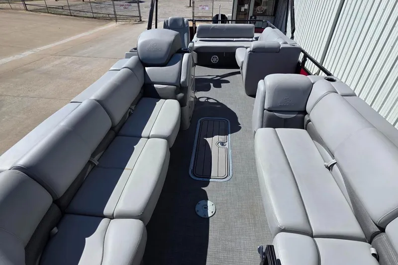 Slide: The Image of 2023 Regency 250 DL3 pontoon boat interior with spacious gray seating and modern design. - 7