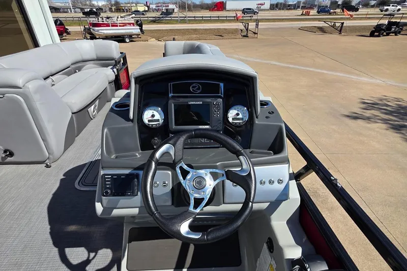 Slide: The Image of 2023 Regency 250 DL3 boat dashboard with steering wheel and control panel. - 8
