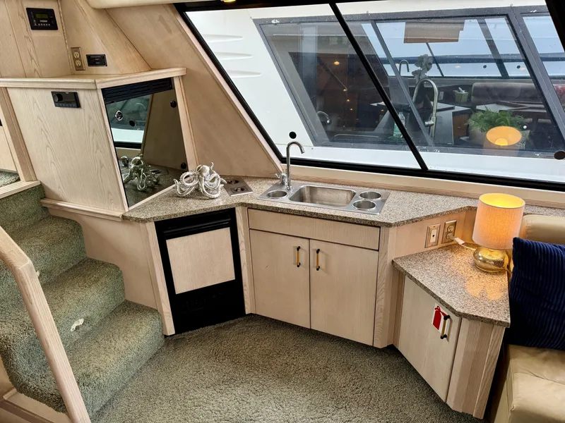 Slide: The Image of Interior of 1996 Bayliner 4788 Pilothouse with kitchenette, sink, and window view. - 11