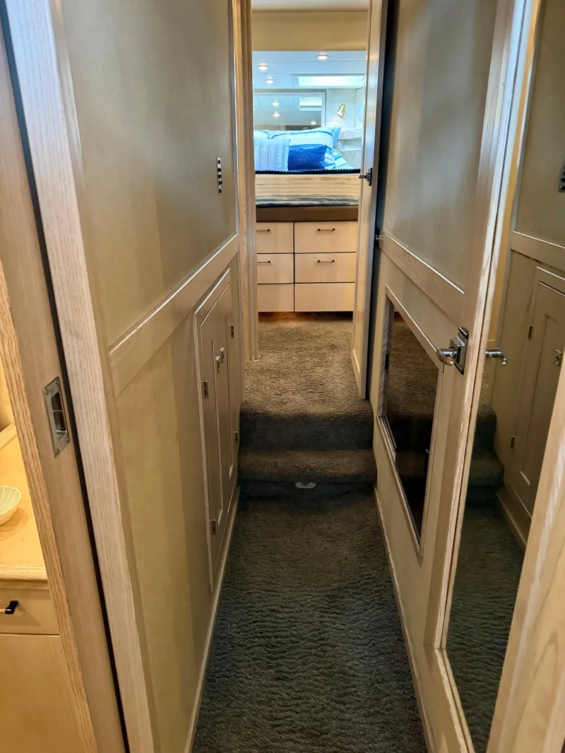 Slide: The Image of Hallway inside 1996 Bayliner 4788 Pilothouse yacht, leading to a bedroom with mirrored door. - 15