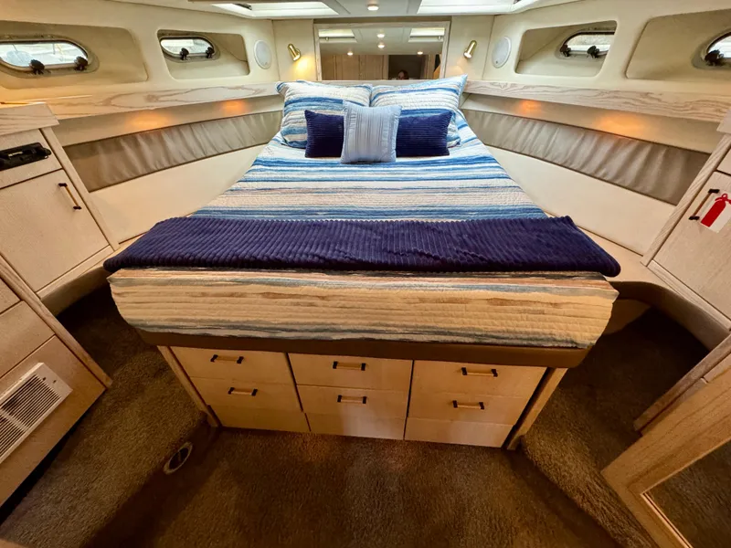 Slide: The Image of Luxurious 1996 Bayliner 4788 Pilothouse cabin with cozy bed and elegant decor. - 16