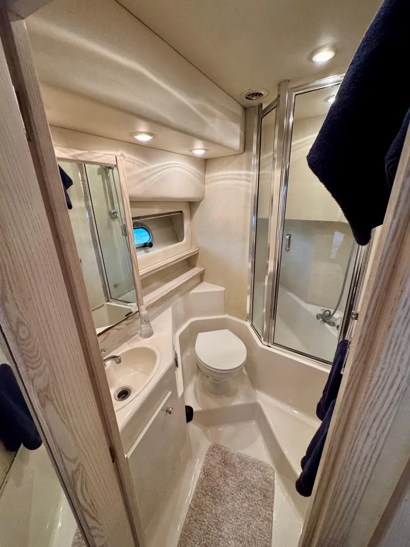 Slide: The Image of 1996 Bayliner 4788 Pilothouse bathroom with shower, sink, and toilet. - 17