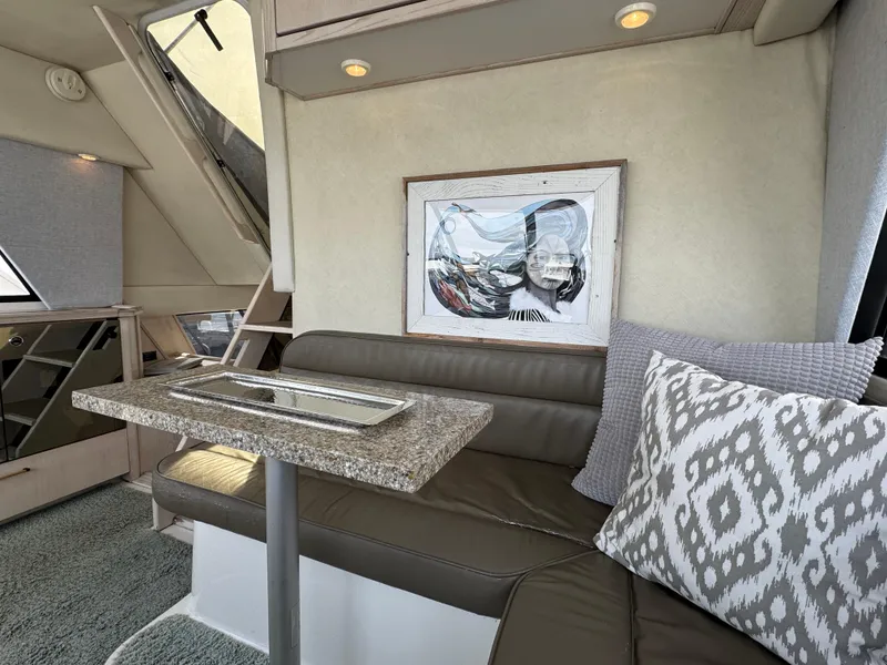 Slide: The Image of Interior of 1996 Bayliner 4788 Pilothouse with seating, table, and artwork. - 29
