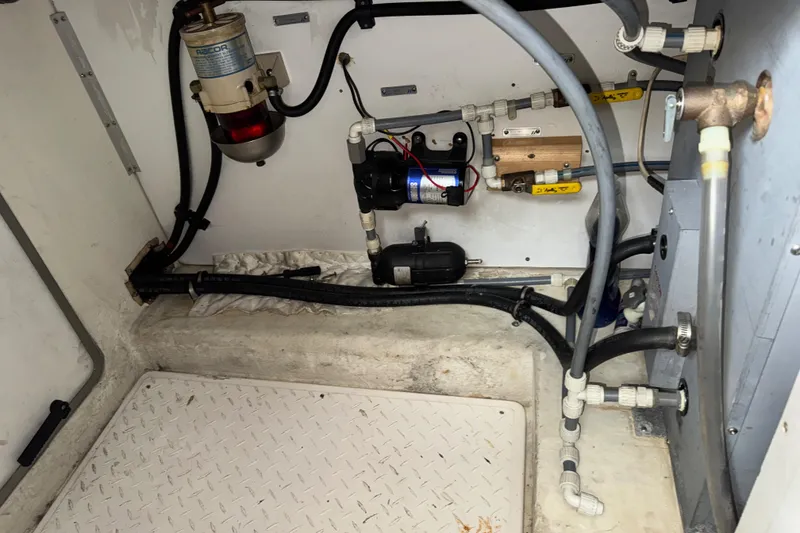 Slide: The Image of Engine room of 1996 Bayliner 4788 Pilothouse with visible plumbing and mechanical components. - 34