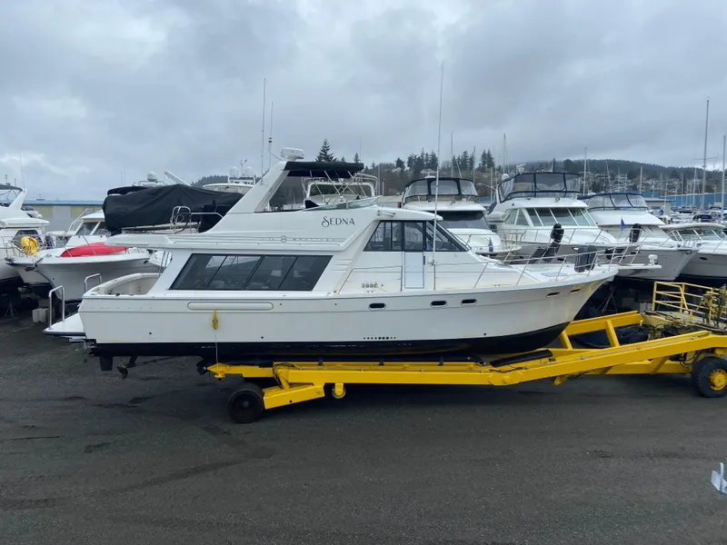 Slide: The Image of 1996 Bayliner 4788 Pilothouse yacht on yellow trailer at marina. - 6