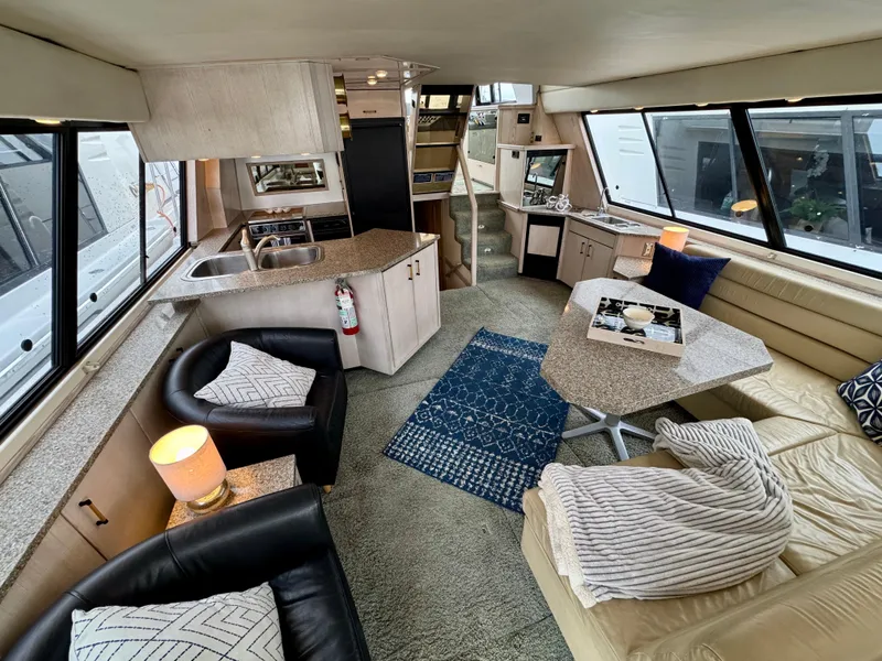 Slide: The Image of Luxurious interior of a 1996 Bayliner 4788 Pilothouse yacht with modern furnishings and ample seating. - 7