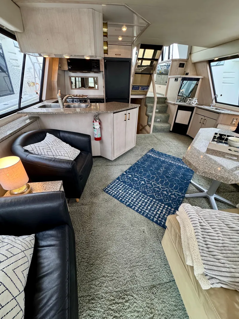 Slide: The Image of Interior of 1996 Bayliner 4788 Pilothouse with modern furnishings and cozy seating area. - 9