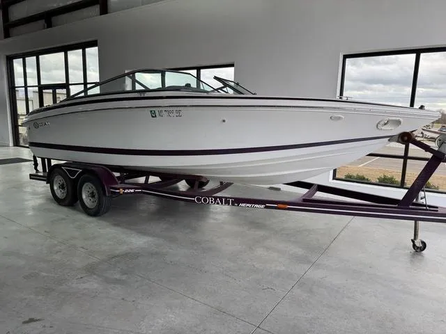 Slide: The Image of 2000 Cobalt 226 boat on trailer in showroom, side view. - 1