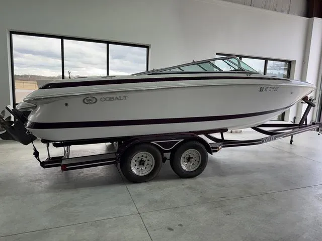 Slide: The Image of 2000 Cobalt 226 boat on trailer in showroom, side view. - 2