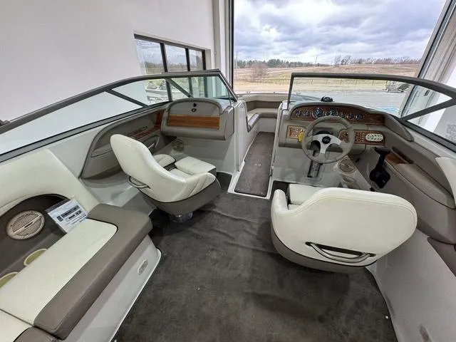 Slide: The Image of Interior of a 2000 Cobalt 226 boat with white seating and modern dashboard. - 4