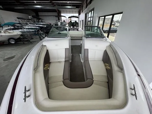 Slide: The Image of Interior of a 2000 Cobalt 226 boat with beige seating in a showroom. - 6