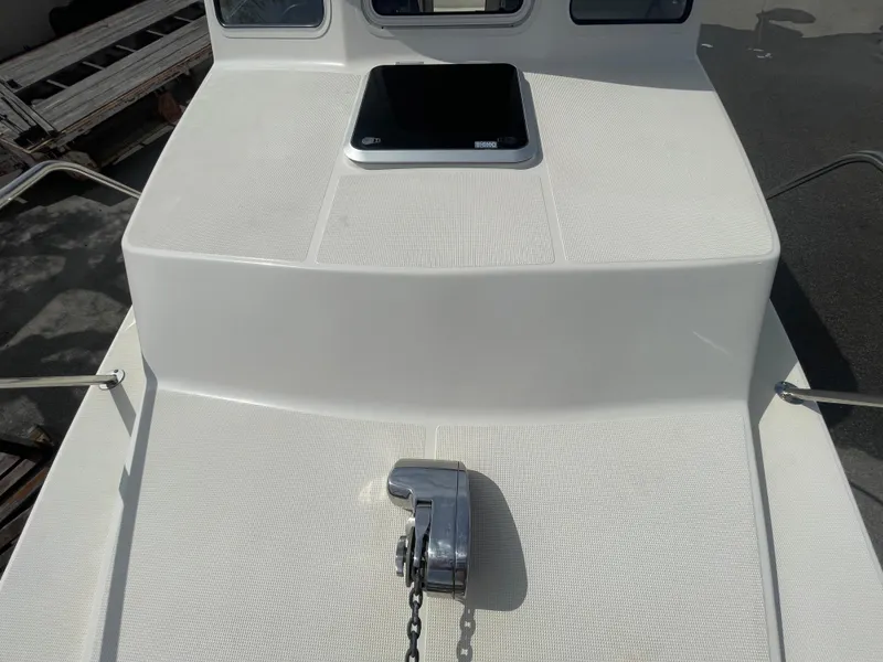 Slide: The Image of 2009 C-Dory TOMCAT 255 boat deck with anchor winch and hatch. - 13