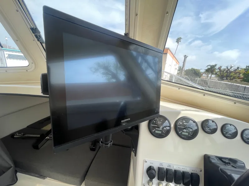 Slide: The Image of 2009 C-Dory TOMCAT 255 dashboard with Garmin display and gauges. - 25