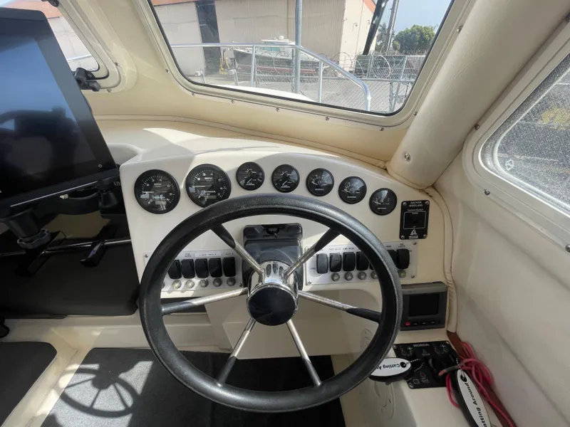 Slide: The Image of 2009 C-Dory TOMCAT 255 helm with steering wheel and instrument panel. - 26