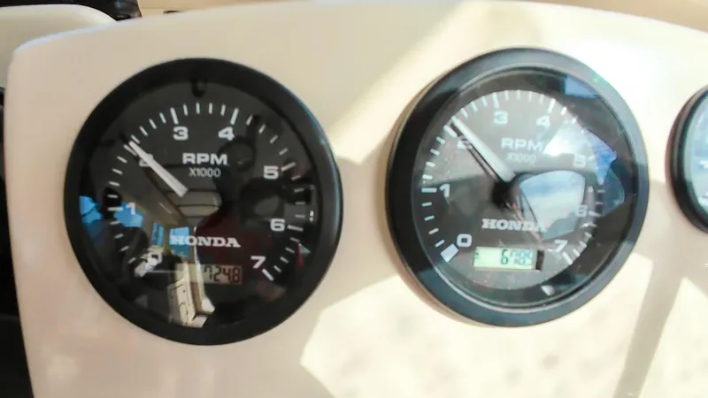 Slide: The Image of Close-up of Honda RPM gauges on a 2009 C-Dory TOMCAT 255 boat dashboard. - 27