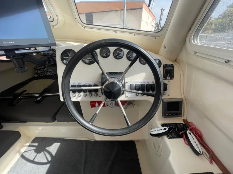 Slide: The Image of 2009 C-Dory TOMCAT 255 helm with steering wheel and instrument panel. - 28