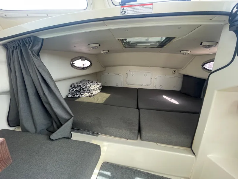 Slide: The Image of 2009 C-Dory TOMCAT 255 cabin interior with cushions and portholes. - 29