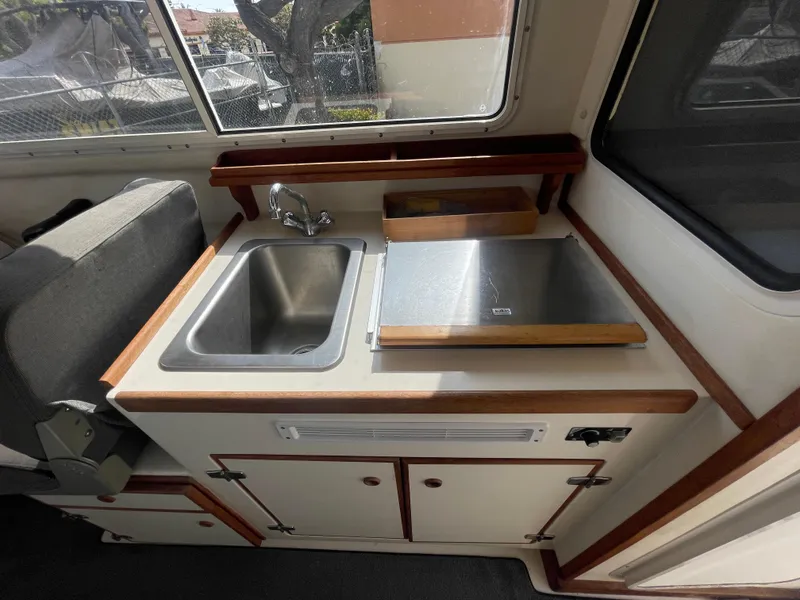 Slide: The Image of 2009 C-Dory TOMCAT 255 interior with sink and counter in cabin. - 37