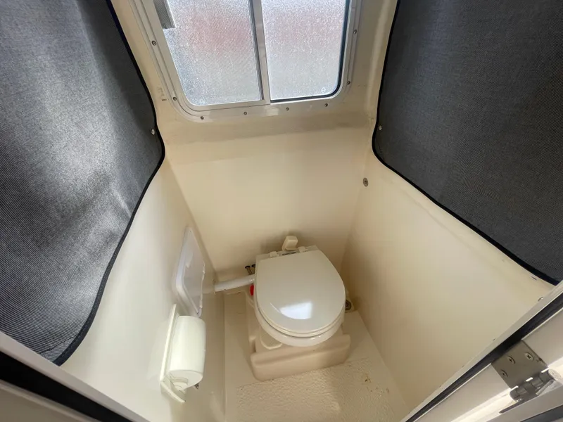 Slide: The Image of Compact marine toilet in 2009 C-Dory TOMCAT 255 boat cabin. - 42
