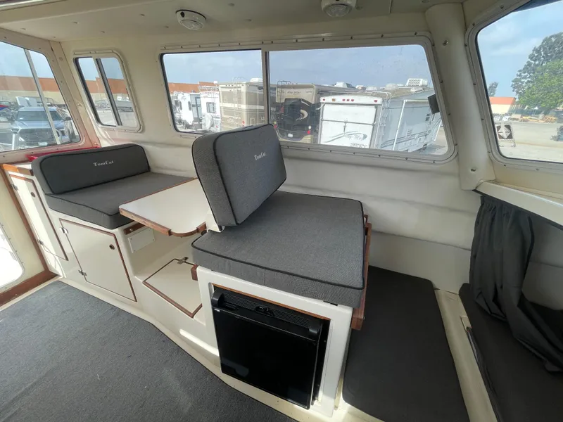 Slide: The Image of Interior of 2009 C-Dory TOMCAT 255 boat with seating and table. - 46