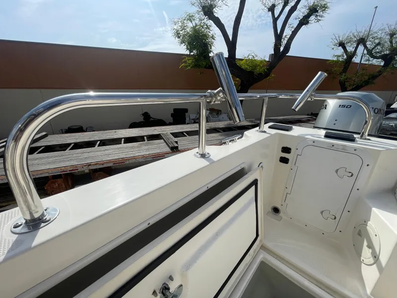 Slide: The Image of 2009 C-Dory TOMCAT 255 boat deck with stainless steel railings and storage compartment. - 48