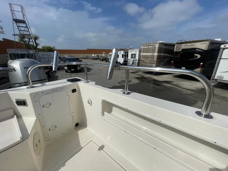 Slide: The Image of 2009 C-Dory TOMCAT 255 boat deck with stainless steel railings and storage compartments. - 49