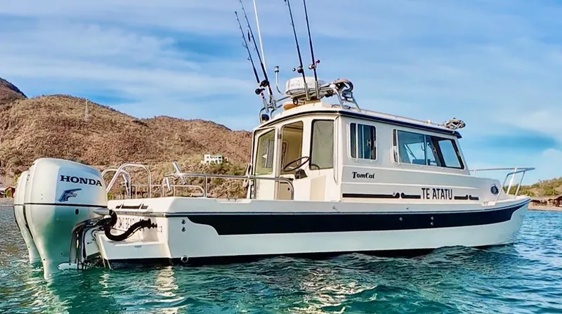 Slide: The Image of 2009 C-Dory TOMCAT 255 boat on water with Honda outboard motor. - 67