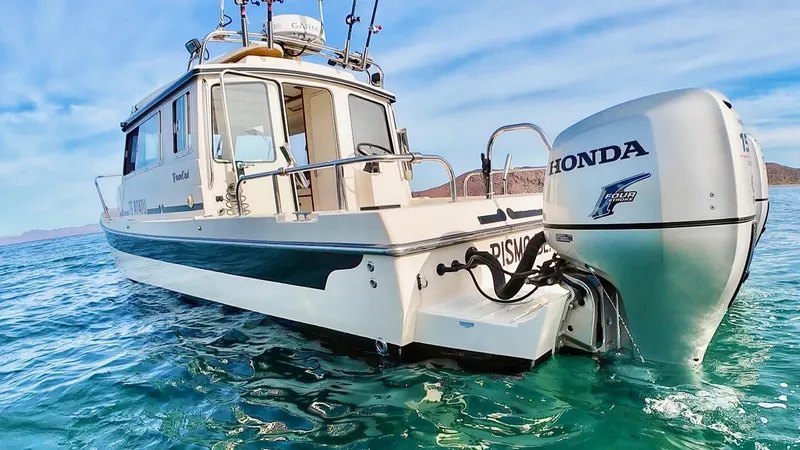 Slide: The Image of 2009 C-Dory TOMCAT 255 boat with Honda outboard engine on clear water. - 68