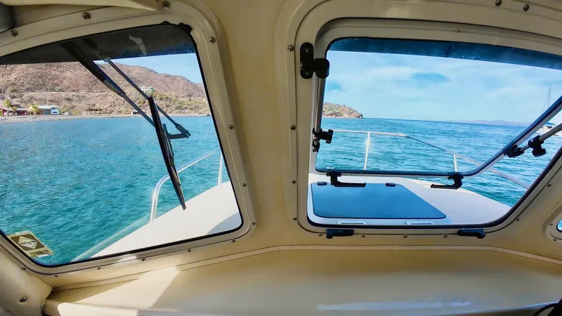 Slide: The Image of View from inside a 2009 C-Dory TOMCAT 255 boat, overlooking clear blue waters. - 73