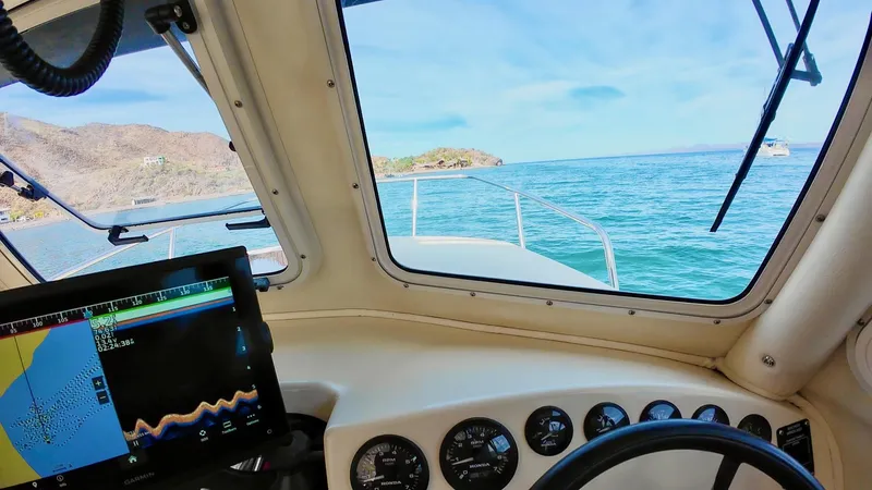 Slide: The Image of Interior view of 2009 C-Dory TOMCAT 255 boat with navigation equipment and ocean scenery. - 74