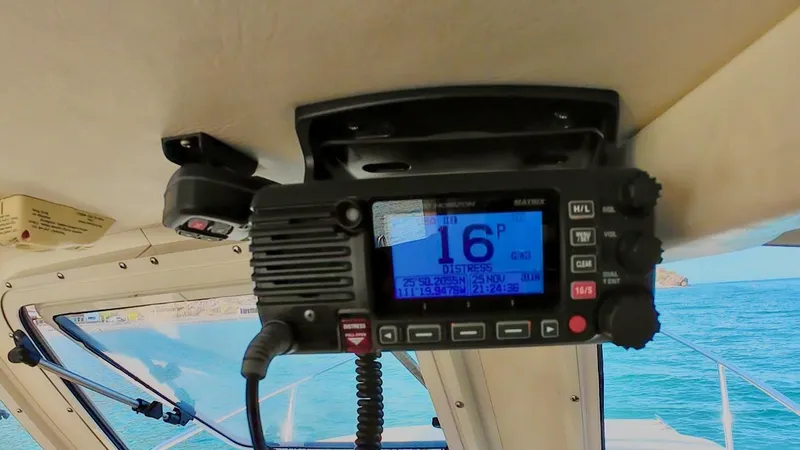 Slide: The Image of VHF radio inside 2009 C-Dory TOMCAT 255 boat, displaying channel 16, with ocean view. - 75