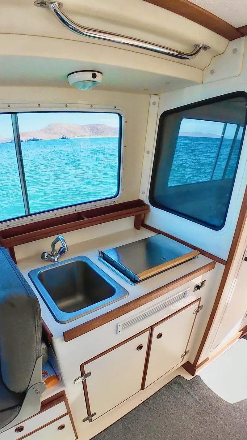 Slide: The Image of 2009 C-Dory TOMCAT 255 boat interior with sink and ocean view. - 76