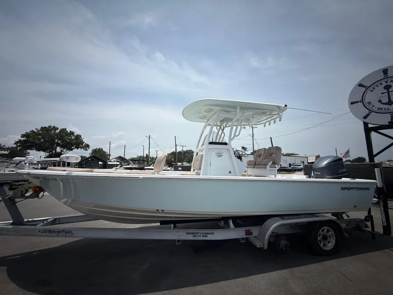 Slide: The Image of 2020 Sportsman Masters 247 Bay Boat on trailer, parked outdoors under cloudy sky. - 11