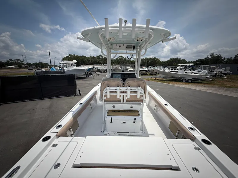 Slide: The Image of 2020 Sportsman Masters 247 Bay Boat, spacious deck, center console, parked outdoors. - 13