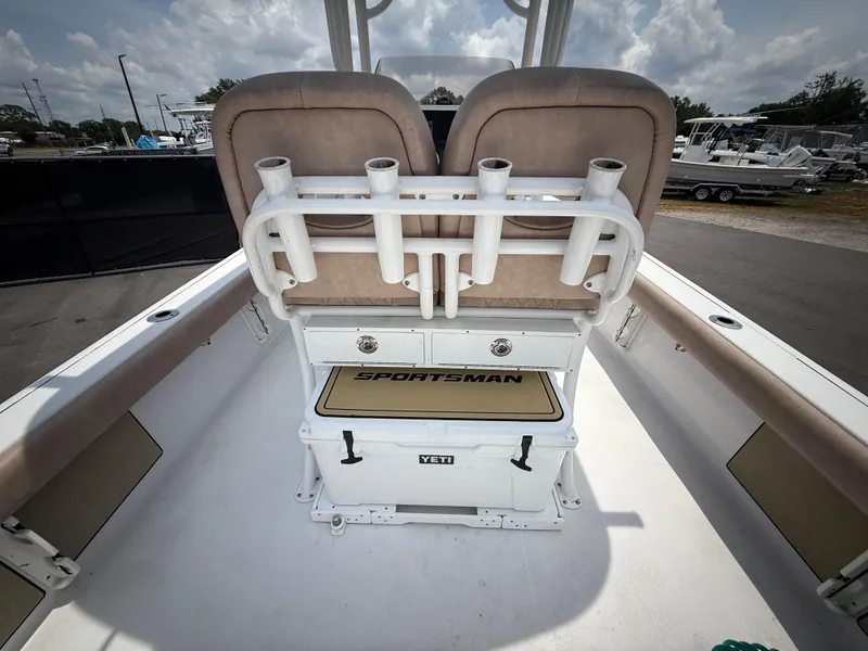 Slide: The Image of 2020 Sportsman Masters 247 Bay Boat interior with rod holders and Yeti cooler. - 15