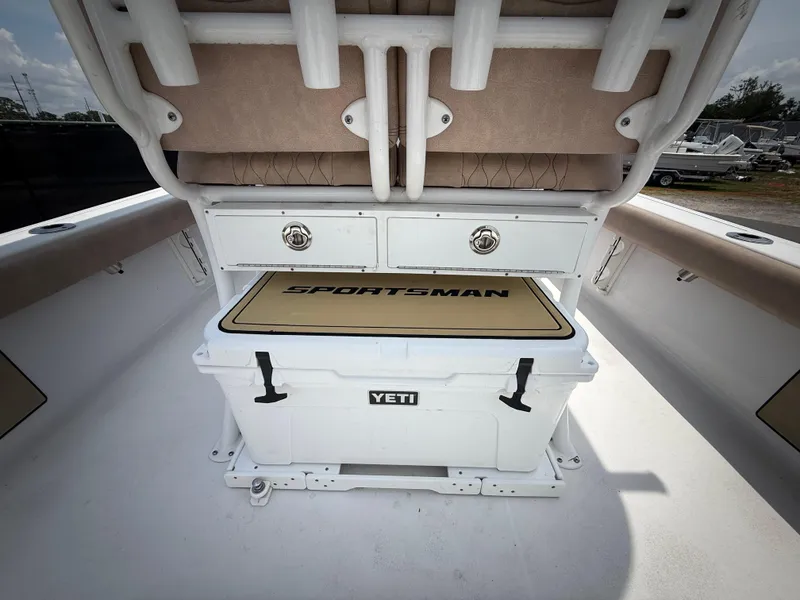 Slide: The Image of 2020 Sportsman Masters 247 Bay Boat interior with Yeti cooler and storage compartments. - 16
